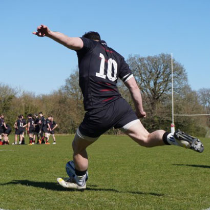 Players celebrate a try with supporters behind the posts
